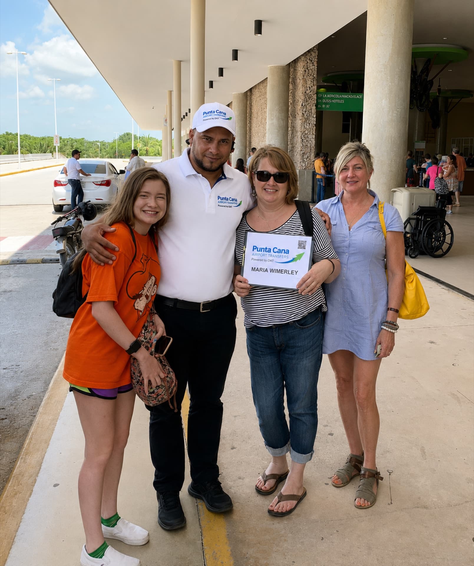 A Punta Cana Airport Transfers driver greeting an arriving family at the airport